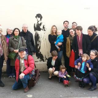Unitarians in London gathered next to an image of 18th century Unitarian writer Mary Wollstonecraft.