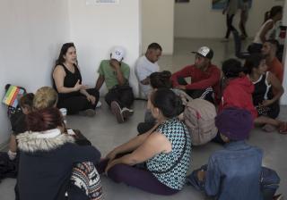 A US volunteer lawyer informs migrants on what to expect when requesting asylum in the US, at an office in Tijuana, Mexico, Friday, April 27, 2018. 