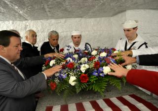 The U.S. president sends a wreath, which representatives from the Navy, local government, the congregation, and the Adams family lay on the Adams family tomb at “the Church of the Presidents,”in Quincy MA