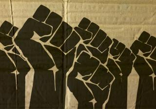 Stock photo of Black Lives Matter fists on a cardboard background