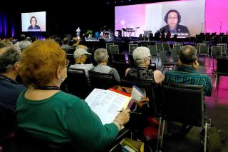UUA Executive Vice President Carey McDonald, participating virtually, explains procedural changes during General Session 1