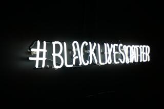 Neon "#BlackLivesMatter" sign at UUA headquarters
