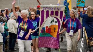 Members of the UU Church of Spokane, Washington, walk in the Opening Celebration banner parade at GA 2019.