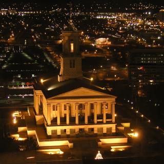 A bird's-eye view of a state capitol building (Tennessee) lit at night.