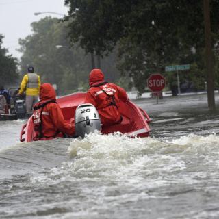 Coast Guard Petty Officers 3rd Class Eric Gordon and Gavin Kershaw pilot a 16-foot flood punt boat and join good Samaritans in patrolling a flooded neighborhood in Friendswood, Texas, Aug. 29, 2017. The flood punt team from Marine Safety Unit Paducah, Ken