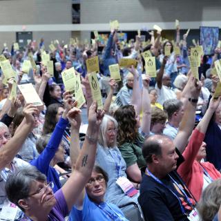 Delegates vote at the 2018 General Assembly to place three proposed Actions of Immediate Witness on the final agenda