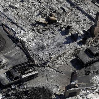 Charred vehicles are seen next to a wildfire-ravaged home in an aerial view Saturday, Oct. 14, 2017, in Santa Rosa, Calif.