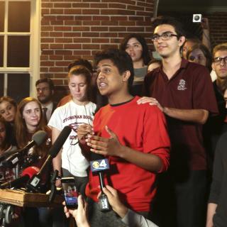 Tanzil Philip, 16, Coral Springs, a sophomore at Marjory Stoneman Douglas High School, center, addresses the crowd outside of Leon High School in Tallahassee, Fla., Feb. 20, 2018. 