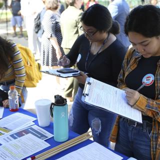 Students fill out voter registration forms at on National Voter Registration Day