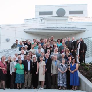 Members of Community Church, UU, gathered on the steps of the rebuilt New Orleans church