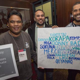 From left: Eltera Hermios, Mark Stege, and Fenton Lutunatabua, Convening participants from the Pacific, receive messages from UUs around the United States, at the First Peoples’ Convening on Climate-Forced Displacement, held in Girdwood, AK, October 1–4.