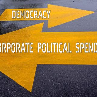 photo illustration of one arrow pointing right with "democracy" written on it and a larger arrow pointing left with "corporate political spending" written on it.
