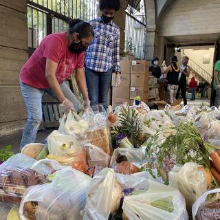 Volunteers assemble grocery bags for a COVID-19 emergency food bank, run by Urban Partners Los Angeles’s Groceries For Our Neighbors program. UPLA shares a close relationship with First Unitarian Los Angeles, whose building is home to the food bank.