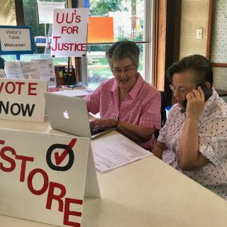 Spouses Linda Wright (left) and the Rev. Robin Gray volunteer at the UU Tallahassee Second Chances Phone Banking event September 22, 2018, in Florida.