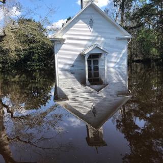 A building at Shelter Neck Unitarian Universalist Camp surrounded by several feet of water, flooded after hurricane Florence