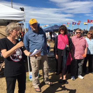 Members of the Quimper, Whidbey Island, and Bismarck Mandan UU congregations stand in front of the people at Oceti Sakowin camp, reading a letter signed by more than 100 UU ministers.