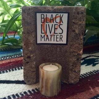 Black lives matter altar created using a cinder block that vandals threw into the Rev. Suzanne Redfern-Campbell's office window.