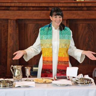 The Rev. Robin Bartlett, who is ordained as both a Unitarian Universalist and United Church of Christ minister, leads communion at First Church in Sterling, Massachusetts, a federated church.