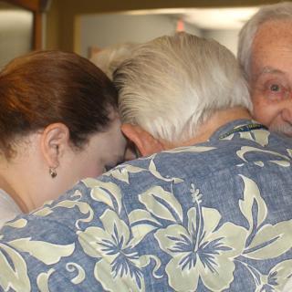 Rafael Cantón (right) leads a group hug with fellow congregants at the UU Church of Ventura, California.
