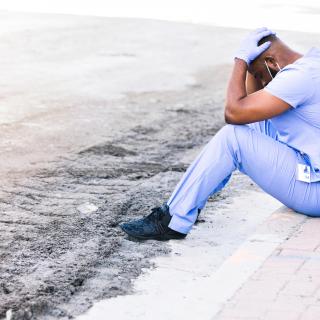 Distraught nurse takes break during COVID shift stock photo