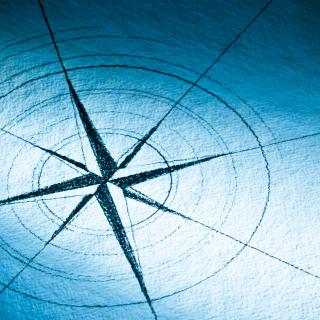 Hand-drawn compass rose on blue paper - Stock image