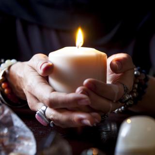 Hands holding a candle - Stock image