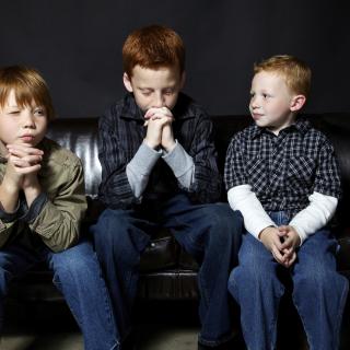 Three brothers practice praying