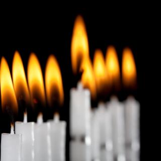 Lit candles from a Hanukkah menorah.