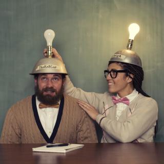 two people with hats with lightbulbs on top
