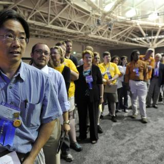 Dr. Jimmy Leung, a delegate from UU Congregation of Phoenix, Arizona, and a long line of other delegates waited to speak at GA 2012