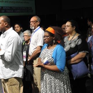 Members of the UU people of color organization DRUUMM introduced a responsive resolution at the end of the final plenary session June 23.