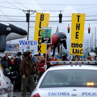 activists close road and face police outside natural gas site near Tacoma, Washington