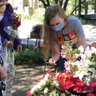 Members of the Unitarian Universalist Church of Arlington, Virginia, participate in a Flower Communion in the congregation's memorial garden in May 2021.