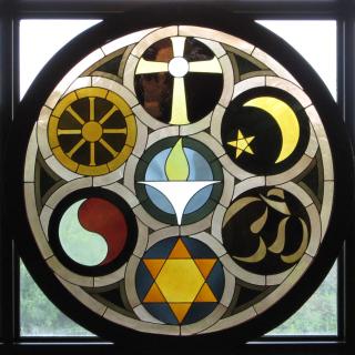 Rehnberg Window UU Church Rockford Ill. Stained Glass window showing symbols of world religions, and a flaming chalice.