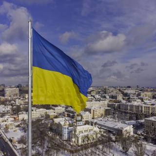 Stock photo of the Ukrainian Flag blowing in the wind over the city of Kharkov.