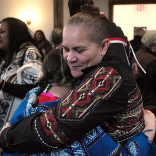 jessie little doe baird hugs an attendee at a November 2017 celebration at the Old Indian Meeting House in Mashpee, Massachusetts
