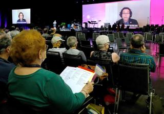 UUA Executive Vice President Carey McDonald, participating virtually, explains procedural changes during General Session 1