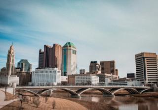 A downtown, urban cityscape under a blue sky in Columbus Ohio.