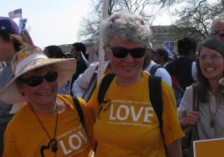 two women wear Standing on the Side of Love shirts 