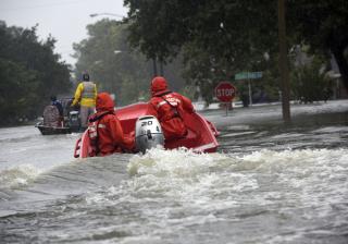 Coast Guard Petty Officers 3rd Class Eric Gordon and Gavin Kershaw pilot a 16-foot flood punt boat and join good Samaritans in patrolling a flooded neighborhood in Friendswood, Texas, Aug. 29, 2017. The flood punt team from Marine Safety Unit Paducah, Ken