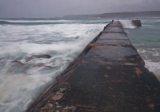 Concrete breakwater with waves 