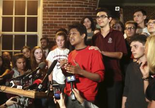 Tanzil Philip, 16, Coral Springs, a sophomore at Marjory Stoneman Douglas High School, center, addresses the crowd outside of Leon High School in Tallahassee, Fla., Feb. 20, 2018. 