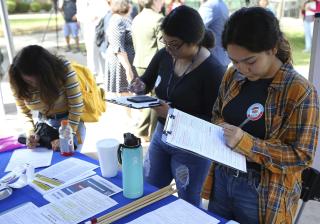 Students fill out voter registration forms at on National Voter Registration Day