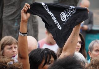 A protester holds a #BlackLivesMatter bandana at a rally in Portland, Oregon, June 28.