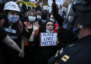 Activists plead with Boston police to "take a knee" during a rally and vigil in Boston on June 2, 2020