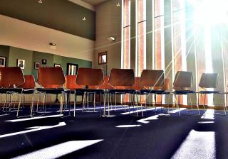 Photograph entitled First UU Congregation of Ann Arbor, Michigan (December 2018). A room with chairs and sunlight streaming in.