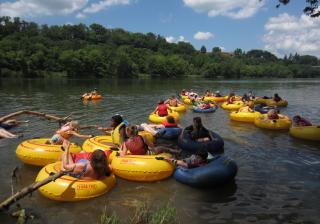 Children take to the river in inner tubes at SUUSI, the largest intergenerational gathering of Unitarian Universalists, in Virginia.