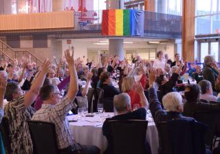 Delegates raise hands at the 2016 Annual Meeting of the Canadian Unitarian Council