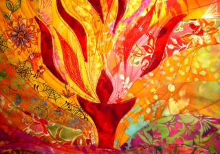 Quilt of a flaming chalice. Reds, oranges and yellows. 