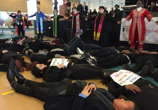 Twin Cities–area UU ministers join interfaith colleagues to form a prayer circle around young adults staging a Black Lives Matter die-in at Macalester College on Martin Luther King Jr. Day.